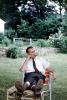 cigar smoking, man, lounging, pants, shoes, tie, backyard, 1950s, PDEV01P02_18