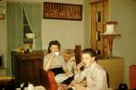 Man, Woman, Sipping Tea, Lamps, fancy lampshade, curtains, 1950s, 1940s