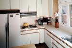 Kitchen sink, gas stove, refrigerator, counters, window