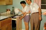 Woman and Man doing the dishes, automatic dishwasher, July 1959, 1950s