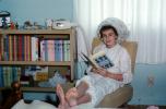 Girl curling hair, dryer, reading book Little Women, books, Pajama, bare feet, January 1964, 1960s, PDRV02P01_18