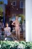 Naked mannequin, window display, glass