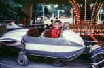 Boy in a jet fighter plane, smiles, Fair Ride, July 1970
