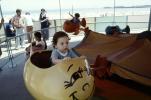 toddler on a ride, kiddie ride, funny face, 1950s