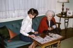Mother and Daughter playing Solitaire, Grandmother