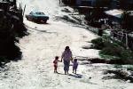 mother, children, walking, car, dirt street, Colonia Flores Magone