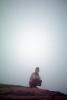 Man Croutching in the Fog, Nepal, PFSV05P05_07