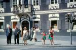 Men, woman, Man, girl, female, costume dress, sidewalk, building, 1963, 1960s, PFSV08P03_18
