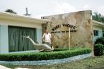 Weeki Wachee, Florida, Dolphin, building, man, bush, wall, 1973, PFTV03P08_04