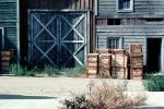 crates, garage door, building, tumbleweed