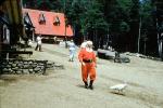 Santa Claus takes a break, red roof building, trees, white peacock bird, boots, belt, Santa's Workshop, North Pole, Adirondack Mountains, 1953, 1950s, PFTV03P10_07