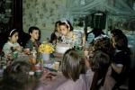 Girl Celebrating being Nine Years Old, blowing out candles, cake, tiara, 1950s, PHBV03P13_19