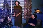 woman, smiles, tinsel tree, Presents, Decorations, Ornaments, Tree, Christmas Tree decorated, 1940s, PHCV02P10_02