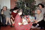 Opening Presents, Gifts, tinsel, baby, grandma, grandmother, mother,  1950s, 1950s