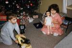 opening presents, boy, girl, robot, tonka toy, Doll, Crane, pajama, nightwear, 1950s