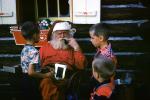 Santa Claus with children, pipe, smoking, belt buckle, hat, log cabin, 1950s