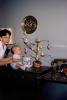Baby looking at an Easter Tree, eggs, decorations, toddler, mother, 1950s, PHEV01P02_03