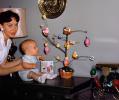 Baby looking at an Easter Tree, eggs, decorations, toddler, mother, 1950s, PHEV01P02_03B