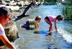 Kids splashing by river, boy, girl