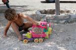 dump truck toy, Boy, pebbles, rocks, tractor