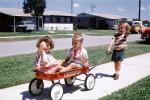 Greyhound pull wagon, boy, girl, brother, sister, sidewalk, suburban, suburbia, cars, 1960s, PLGV03P04_18