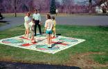 Parcheesi board game, towel, cloth, girls, boys, frontyard, May 1968, 1960s