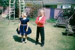 Backyard, boy, girl, dressy, formal dress, smiles, April 1960, 1960s