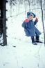 Girl on a Swing in the middle of winter, snow, cold, coat, mittens, 1950s