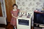Girl with her toy oven and stove, frying pan, 1960s, PLGV04P02_09