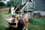 Wheelbarrow, backyard, hats, trash cans, June 1966, PLGV04P03_05