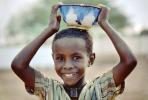 Smiling Boy Carrying a Bowl on his Head, Somalia