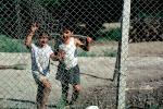 Boys behind a fence