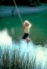 Girl Swings on a Rope, pond