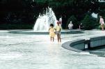 Boy and Girl Wading in Water Fountain