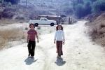 Kids walking down the street, Dirt Road, Rural, 1960s, unpaved