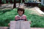 Boy Shows off School Work, car, 1970s