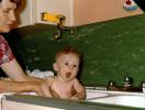 Cute Baby in a Kitchen Sink Bath, Mother