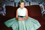 Cute Girl Sitting on a Sofa, green dress, 1950s, PLPV17P12_01