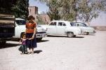 Mother and her Child in a parking Lot, Cars, 1950s