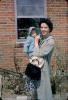 Woman with Baby, Bonnet, Brick House, Smiles, 1950s, PMCV04P04_03