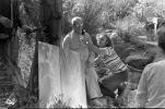 Wernher Krutein holds up light meter, Bucky at a filming session, Topanga Canyon, POF35V06P08_03