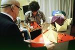 Bucky preparing polyhedra models, "Conversations with Buckminster Fuller" event, Oakland, POFV02P15_13