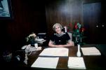 Executive Woman at Desk, phone, flowers