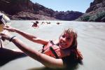 Nancy floats in the river, Colorado River, raft trip