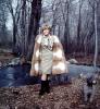 Woman shows off her fur coat and dress, Poodle, forest, winter, cold, May 1967, 1960s, PORV24P07_04