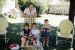 Backyard, mother, sister, brother, siblings, lawn chair, doghouse, 1950s, PORV25P06_05