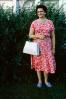 Woman Standing with Purse, dress, smiles. July 1962, PORV31P01_14