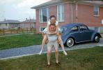 Man and Woman Goofing, Piggyback, Volkswagen Beetle Car, July 1959