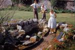 Woman and Men in a Garden, Pond, August 1959, 1950s