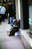 Homeless Woman Sitting at a Sidewalk, POUV01P08_14